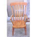 A Windsor farmhouse elbow chair with lath back and elm panel seat