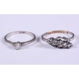 A 9ct gold and silver crossover ring set five diamonds and a platinum and diamond solitaire ring