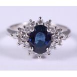 An 18ct white gold sapphire and diamond cluster ring, central sapphire 1.42ct, ring size L, 4g