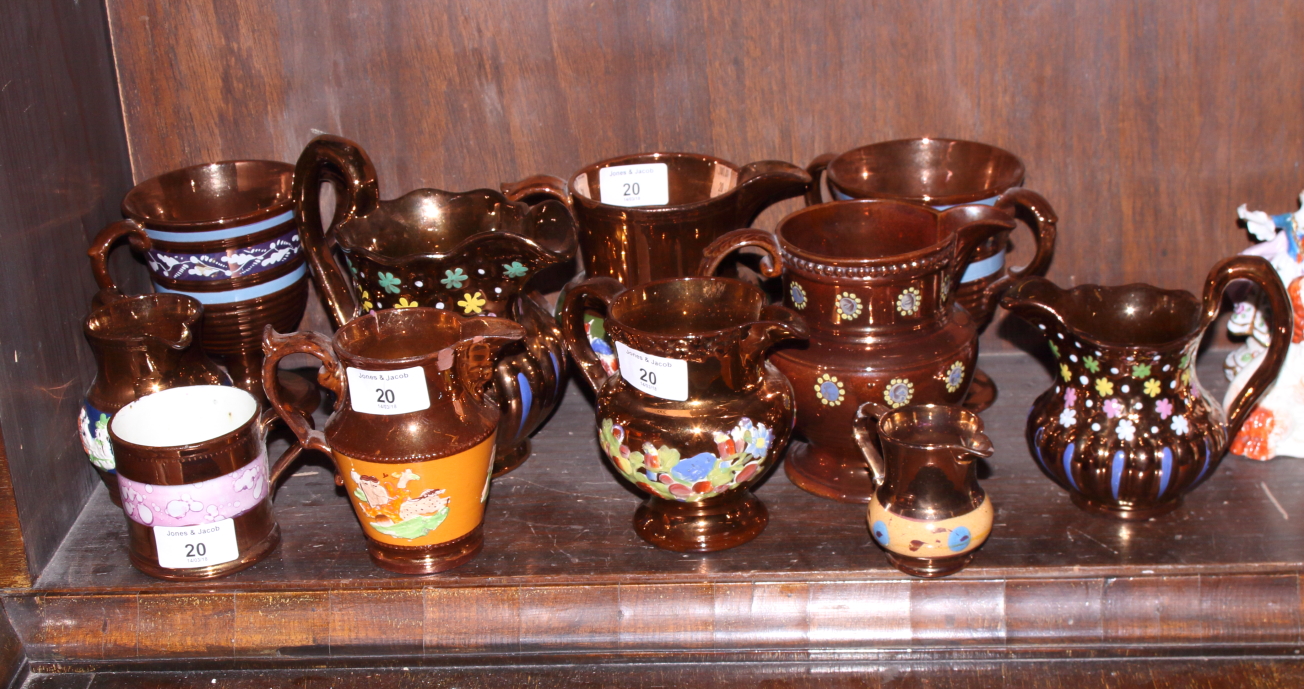 A collection of 19th century copper lustre jugs and a pair of two-handled goblets