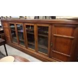 A late 19th century mahogany side cabinet enclosed four glazed panel and two mahogany fielded