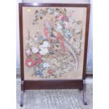 An early 20th century needlework fire screen, in walnut frame, 25" wide