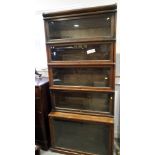 An oak Globe Wernicke five-section bookcase with lift up glazed doors, 34" wide