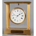 A gilt brass cased mantel clock with quartz movement and enamelled dial by Jean Roulet, 9 1/2" high