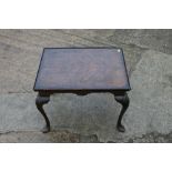A figured walnut and banded low occasional table, on shell carved cabriole supports, 24" wide