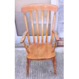 A Windsor farmhouse elbow chair with lath back and elm panel seat