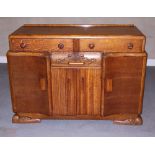 A mid 20th century oak sideboard, fitted two drawers and lower cupboards, 54" wide