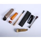 A 9ct gold faced cigar piercer, a 9ct gold cheroot holder, a similar white metal cheroot holder,