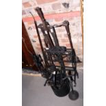 An assortment of black painted wrought iron fire implements