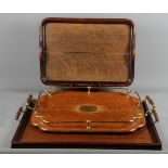 Three oak two-handled trays, various designs