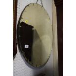 A 1930s circular cut glass aged wall mirror, 24" dia