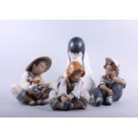 Four Lladro figures, two figures of children, Oriental girl with puppy and child wrapped in a rug