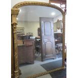 A Victorian arch top overmantel mirror, in gilt gesso decorated frame, 54" x 74"