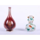 A Chinese porcelain double gourd-shaped snuff bottle, decorated bats and peaches, seal mark to base,