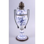A 19th century German porcelain blue and white oil lamp base, three paperweights, two enamelled
