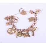 A 9ct rose gold charm bracelet with a 9ct gold heart clasp, complete with various gold charms, 38.5g