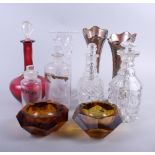 A cut glass table lustre, two cut glass decanters, a ruby glass decanter, a pair of lustre vases and