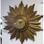 A carved gilt sunburst wall clock, 18" dia
