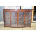 A late 19th century mahogany breakfront bookcase with dentil cornice over four astragal glazed panel