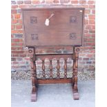 An Arts & Crafts carved oak vargueno type writing desk with fall front, on turned and stretchered