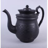 An early 19th century basalt ware coffee pot with lathe turned decoration, 9" high