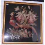 A 19th century needlepoint panel of a pheasant and flowers on a black ground, 28" x 31", in gilt