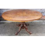 A Victorian figured walnut oval top loo table, on quadruple splay supports, 58" x 46"