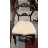 A set of four Victorian carved rosewood side chairs with stuffed over seats, on cabriole supports,