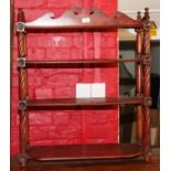 A 19th century mahogany four-tier open wall hanging shelf with shaped crest, 28" wide