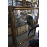 A bevelled plate wall mirror, in swept pale gilt swept frame, 42" x 51"