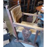 An oak rush envelope seat and back low armchair, on carved panel end supports