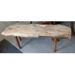 A rustic yew plank top low coffee table, on splay supports, 44" wide