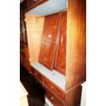 A Georgian mahogany wardrobe, the upper section enclosed two doors over two short and one long