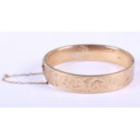 A 9ct gold engraved bangle, 18.7g