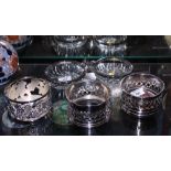 Three silver plated bottle coasters, various, and a bonbon dish with duck decoration