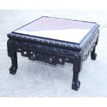 A Chinese carved hardwood coffee table, on paw feet, 23" square