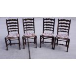 A set of four ladder back dining chairs with rush seats