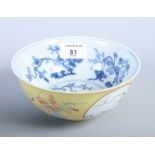 A Chinese porcelain bowl decorated peaches and foliage on a yellow ground, the inside decorated