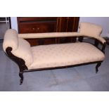 An early 20th century chaise longue with return, stained frame and upholstered in a gold patterned