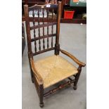 A 19th century spindle back rush envelope low seat chair, on turned and stretchered supports
