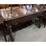 A 19th century carved oak drop leaf side table, on spiral turned and stretchered supports, 52" wide