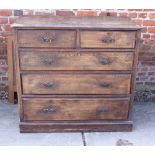 An early 20th century dark stained oak chest of two short and three long drawers