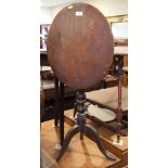 A late Georgian mahogany oval tilt top occasional table, on turned column and tripod splay