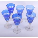 A set of six blue cut glass goblets, two green glass goblets and other coloured glass, various
