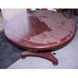 A Victorian circular mahogany tilt top dining table, on turned central stem and triangular base, 42"