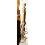 A late 19th Century brass telescopic standard lamp with scrolled decoration and paw feet