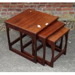 A nest of three 1960s teak occasional tables, on shaped supports
