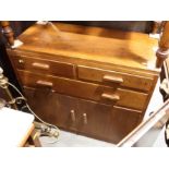 A 1930s oak chest of two short and one long drawer over cupboards, on block base, 33" wide