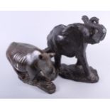 An African carved green stone model, charging elephant, 13" high, and a companion rhinoceros, 8"