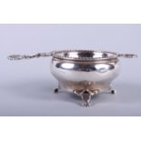 A silver tea strainer and stand with cast shell handle, by Hukin & Heath, 3oz troy approx